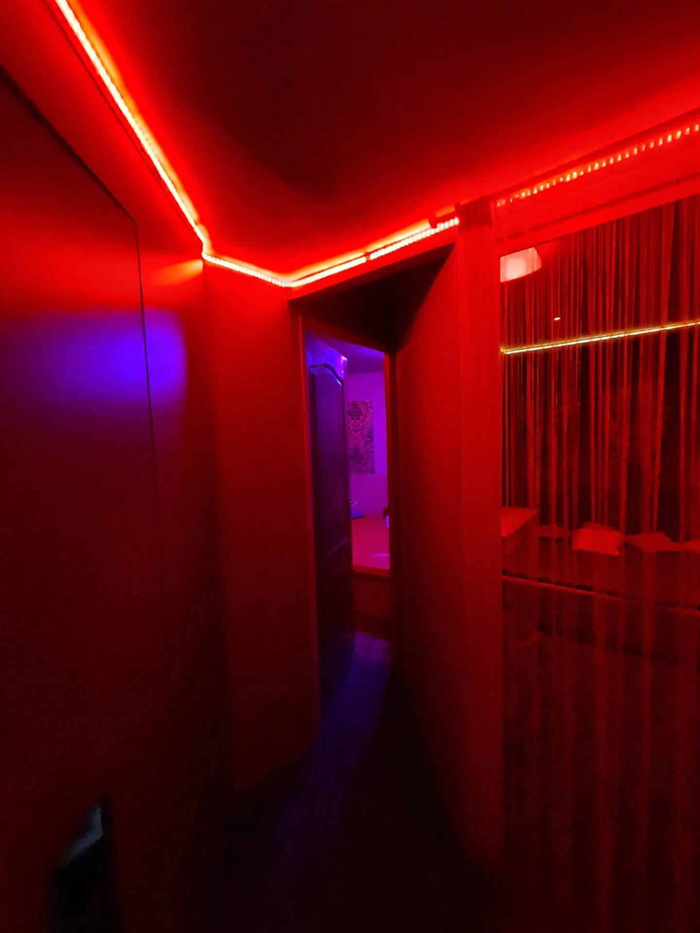 Red corridor with a beaded-curtain doorway