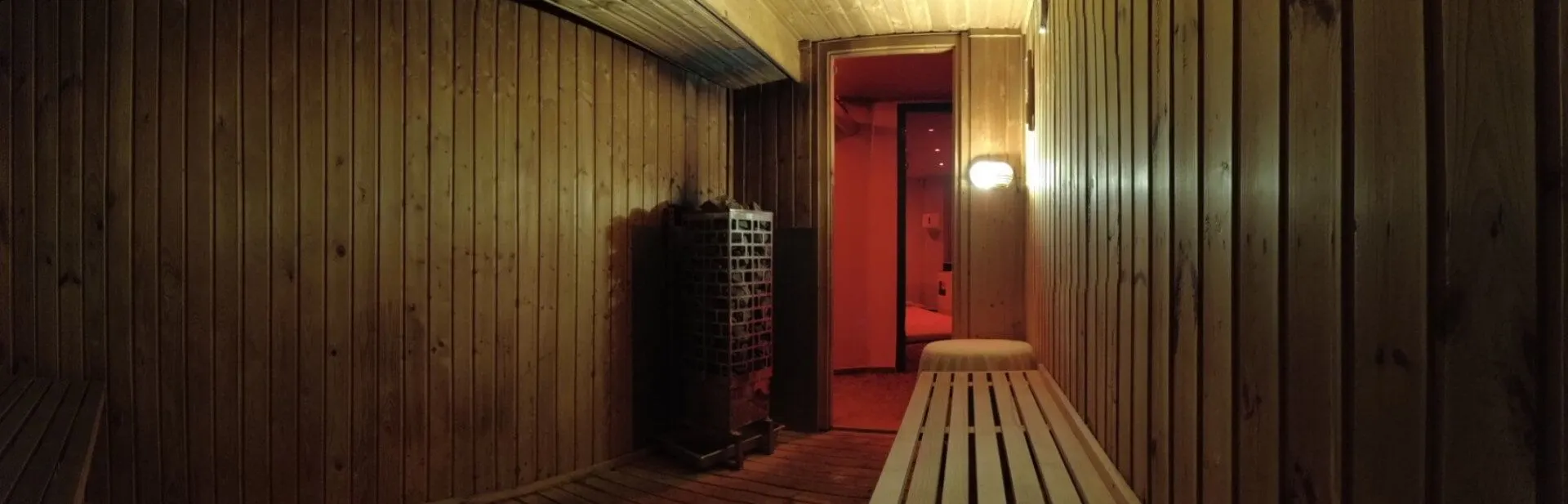 Panoramic view of the sauna interior in warm lamplight