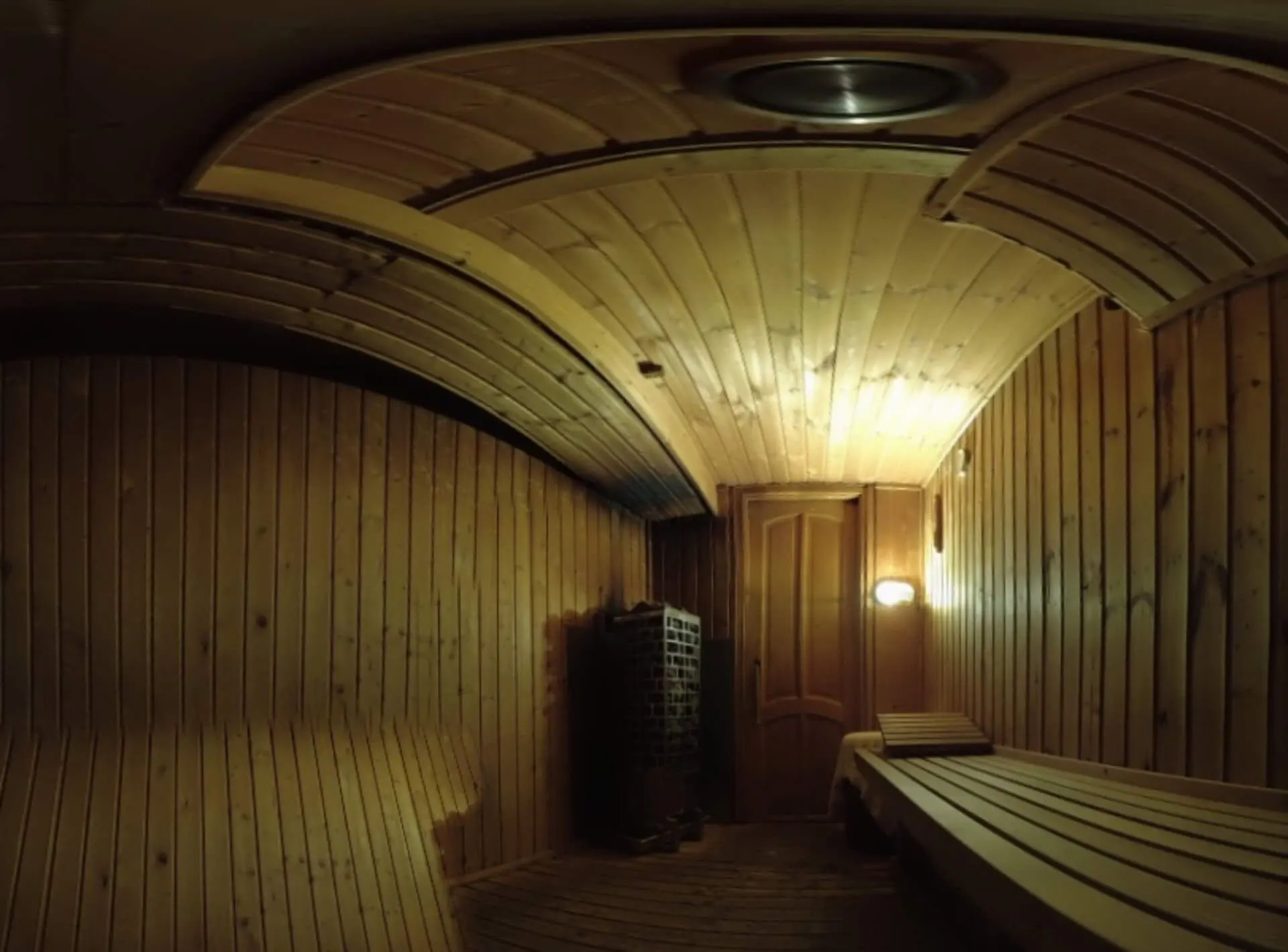 The sauna ceiling and benches in warm light