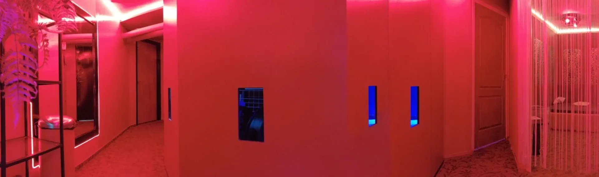 Red-lit corridor with blue-lit doorways