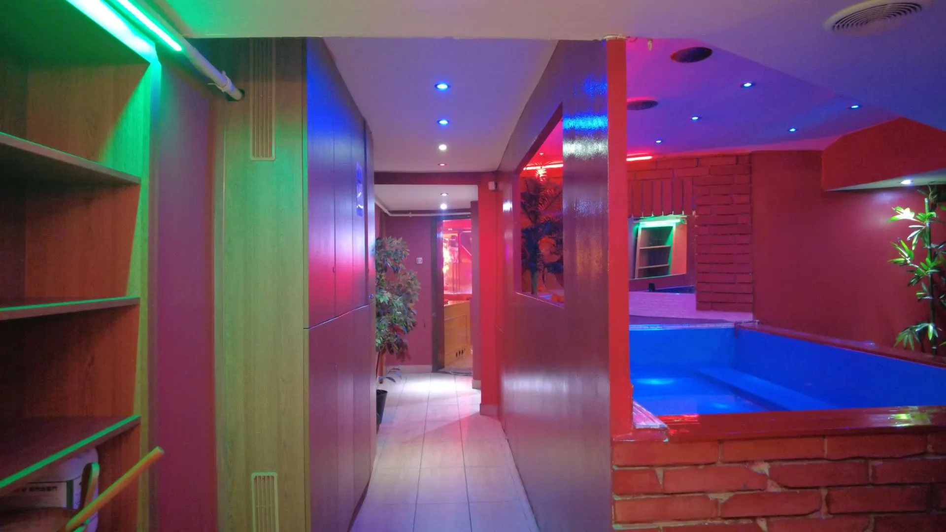 View along the corridor towards the jacuzzi with green and blue lights