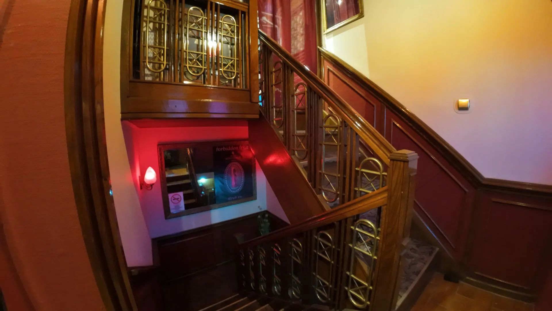 Staircase with carved wooden railings at the club entrance