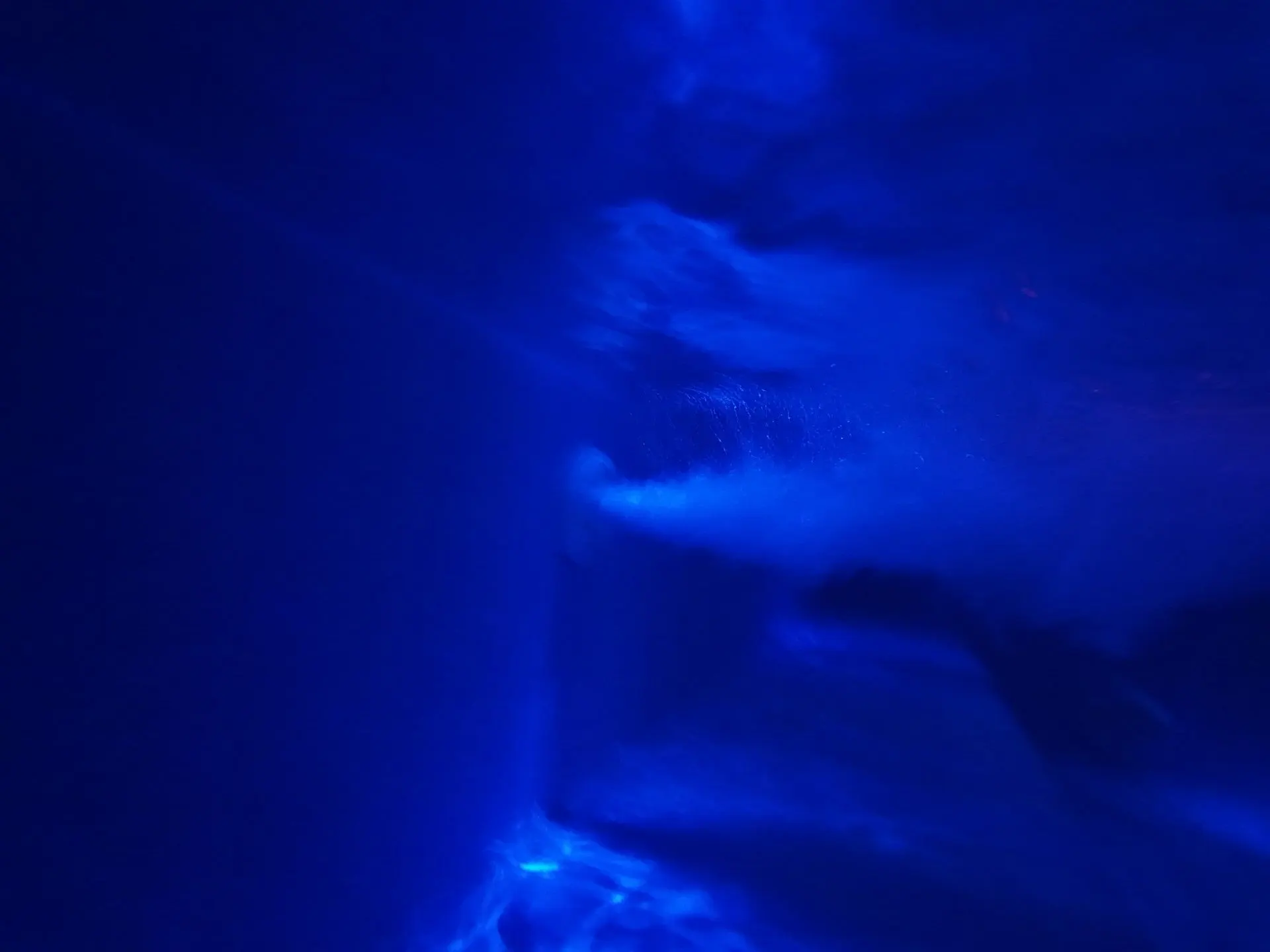 Underwater shot of the jacuzzi in deep blue light