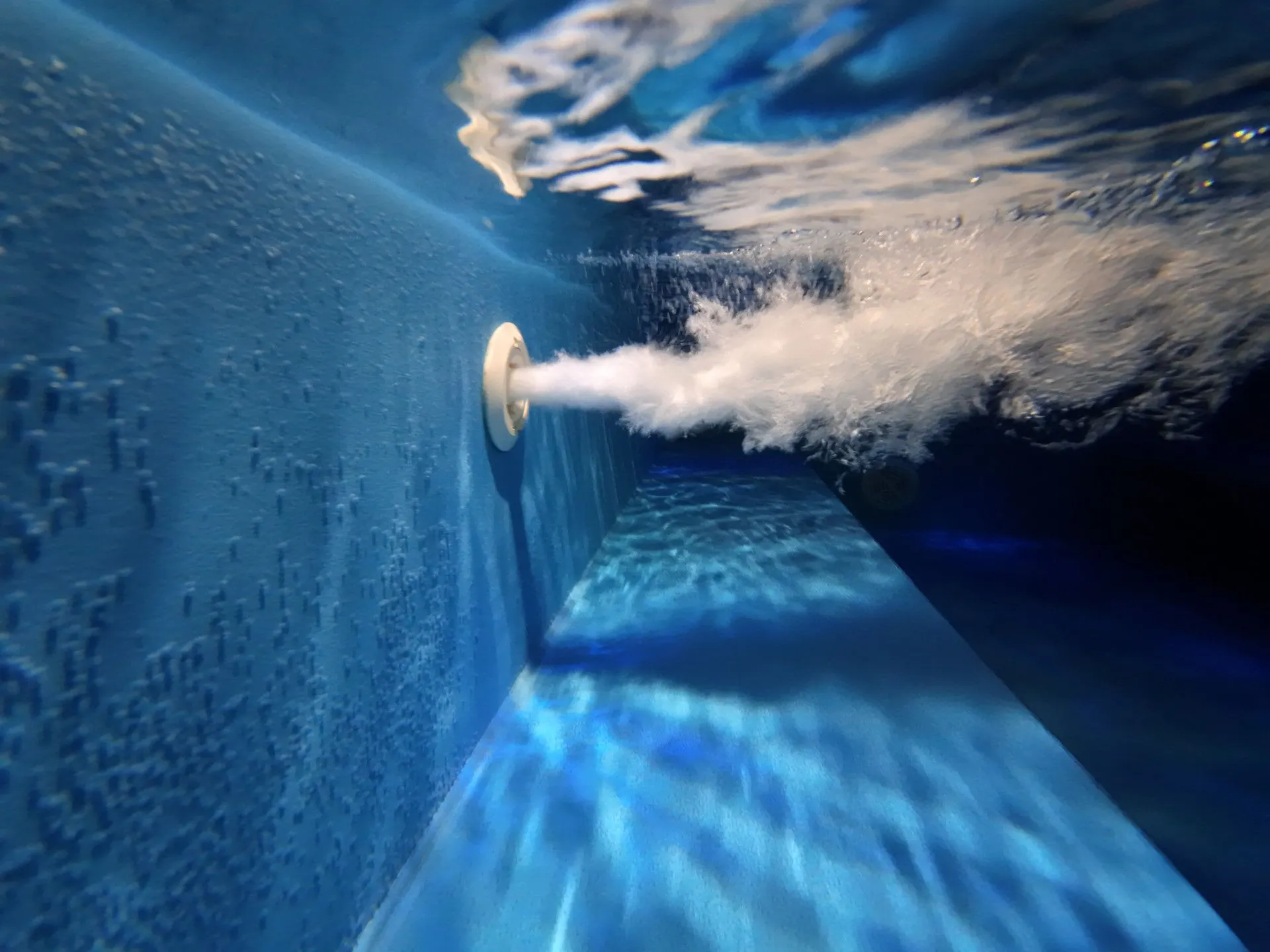 Underwater massage jet with bubbles in the jacuzzi