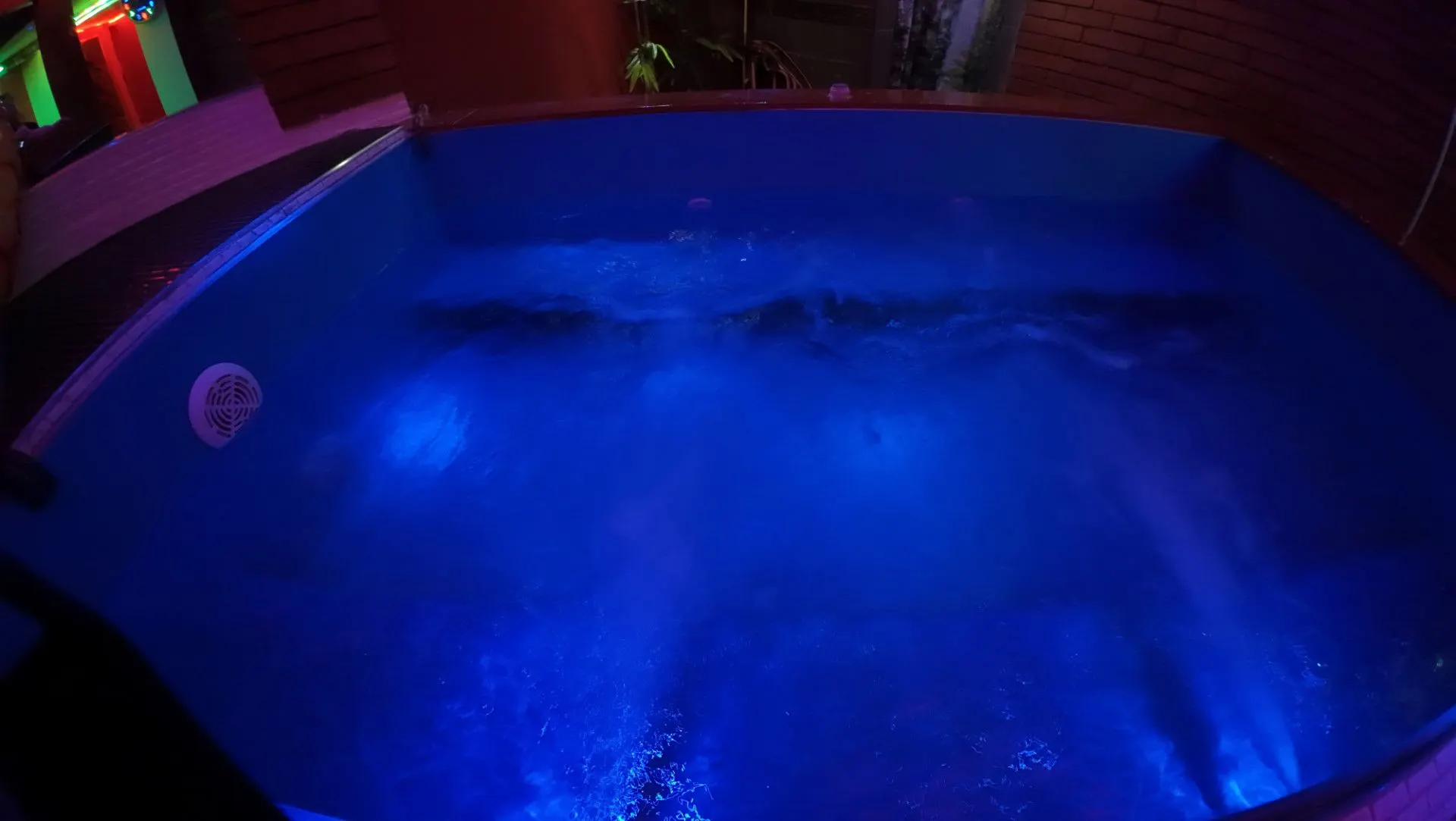 Bubbling jacuzzi in blue light seen from above